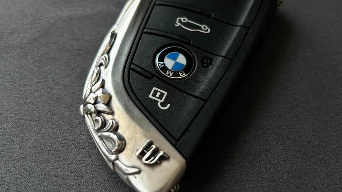 BMW Slim Edge silver key case with exposed factory button face