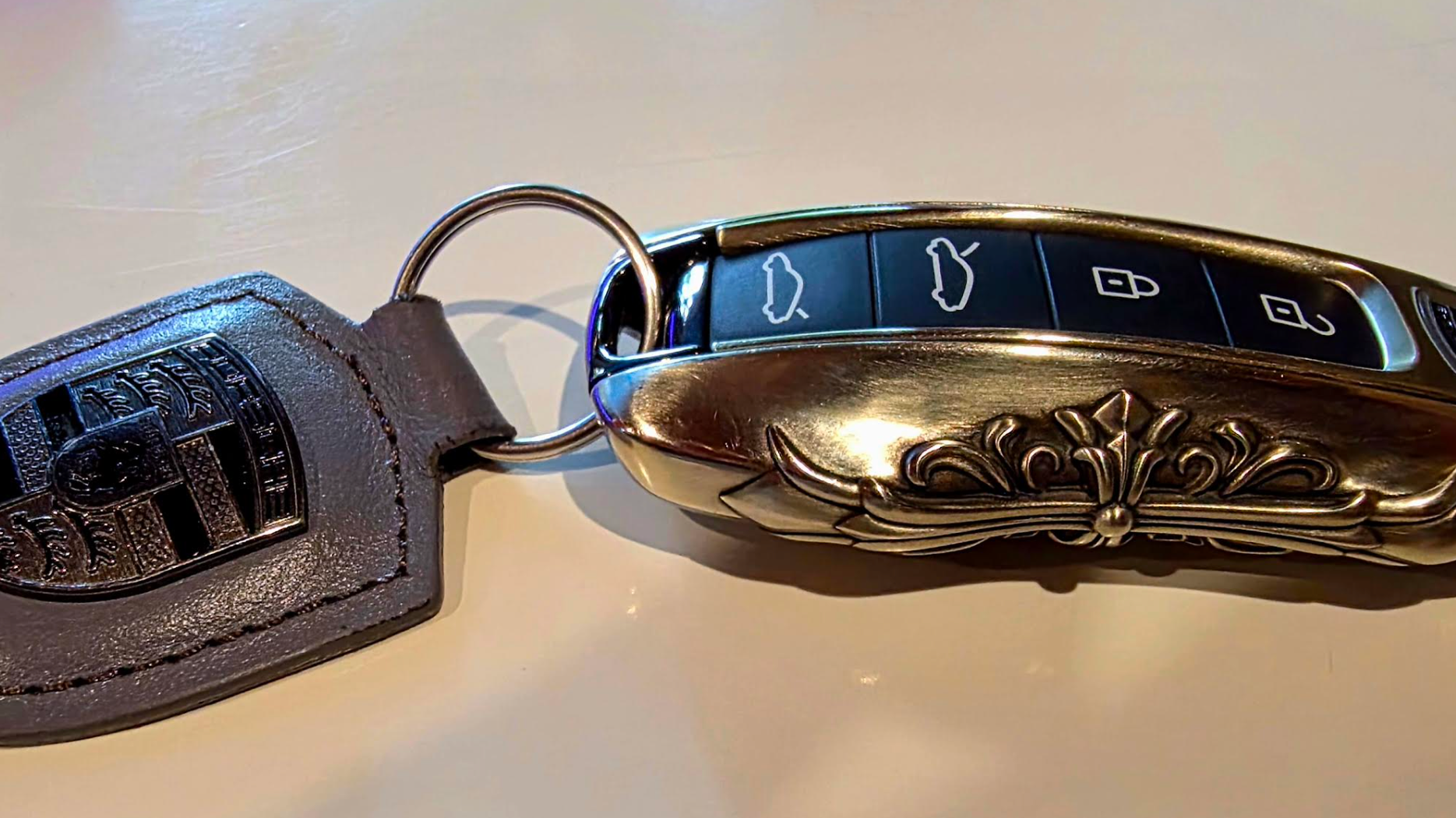 Customer photo of an IGNIS ARGENTUM key case showing fit and finish beside the original vehicle key