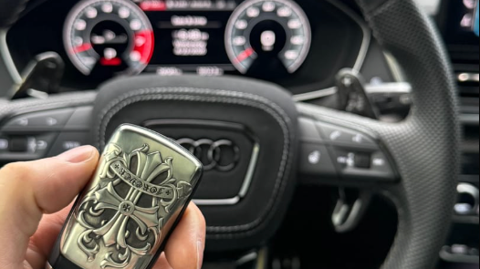 Customer in-car photo showing an IGNIS ARGENTUM key case after installation with clear button access
