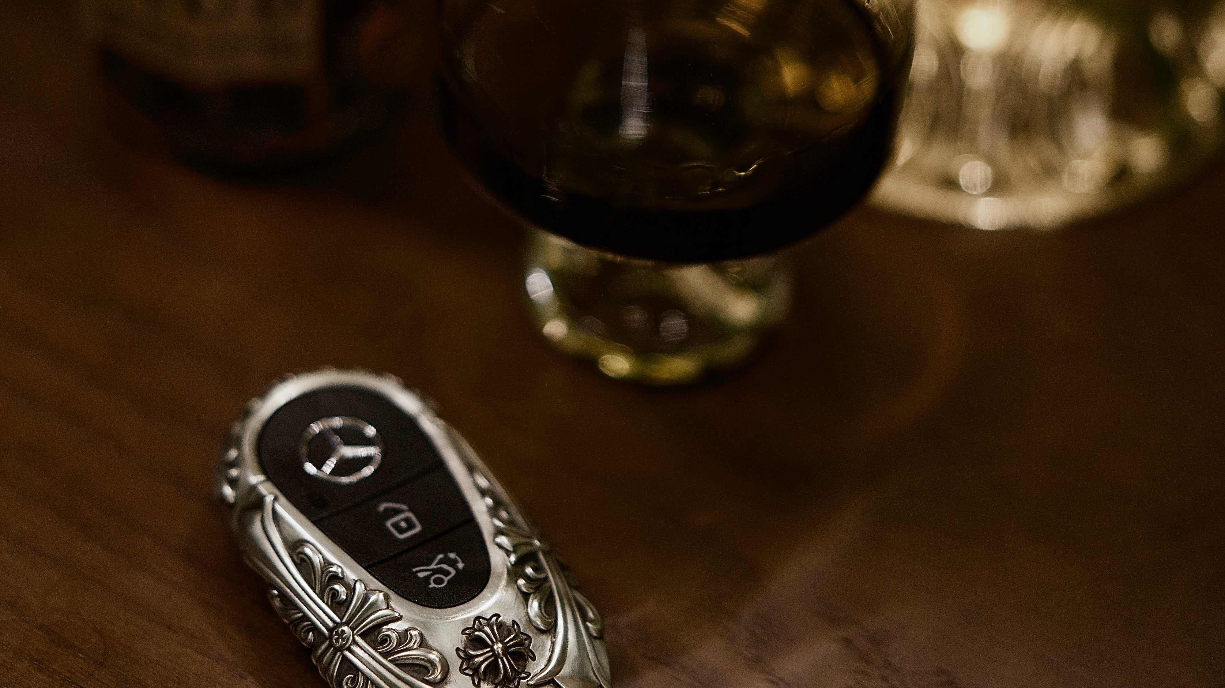 Mercedes-Benz key case lifestyle image showing a quiet luxury gift feel on a wooden table