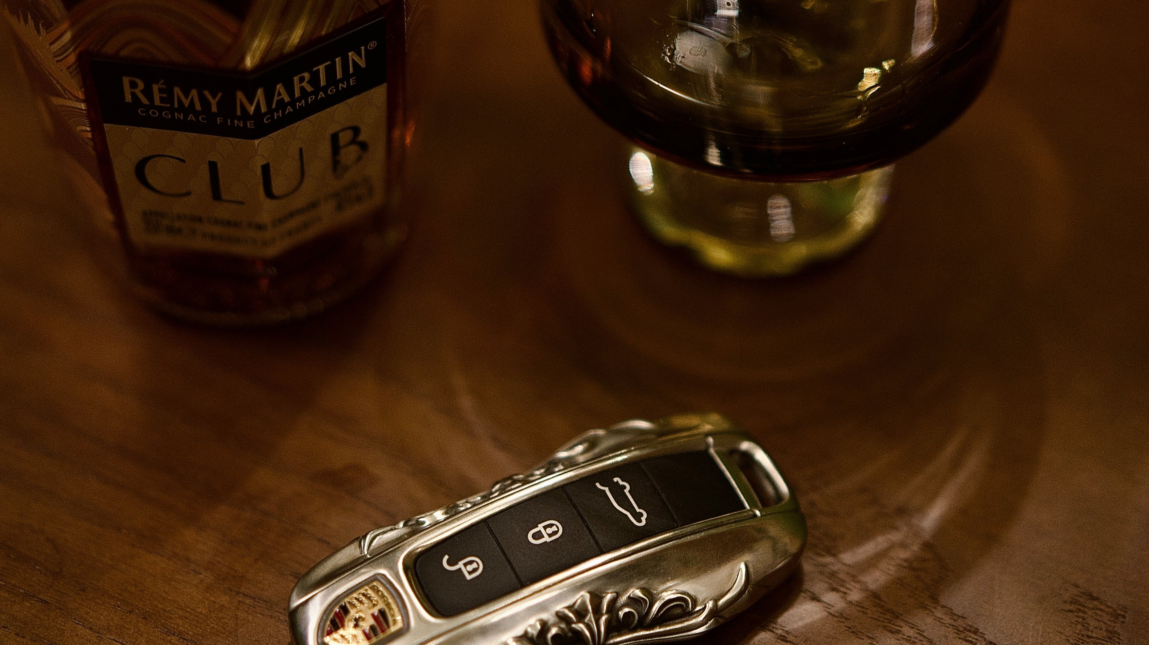 Porsche key case on a wooden desk showing subtle useful luxury and a mature gift choice
