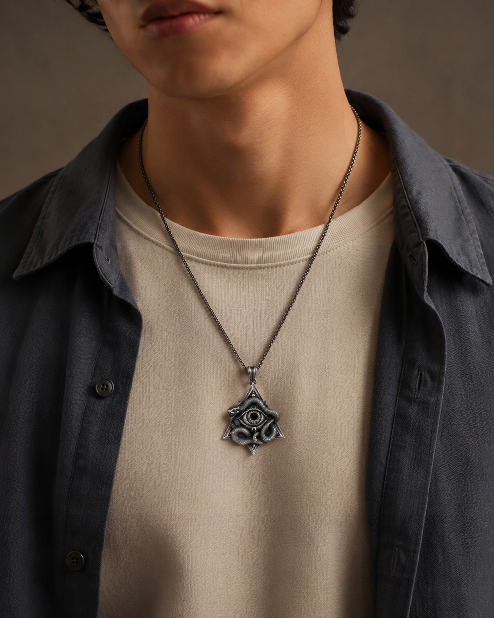 All-Seeing Eye Serpent Pendant, displayed on a dark surface