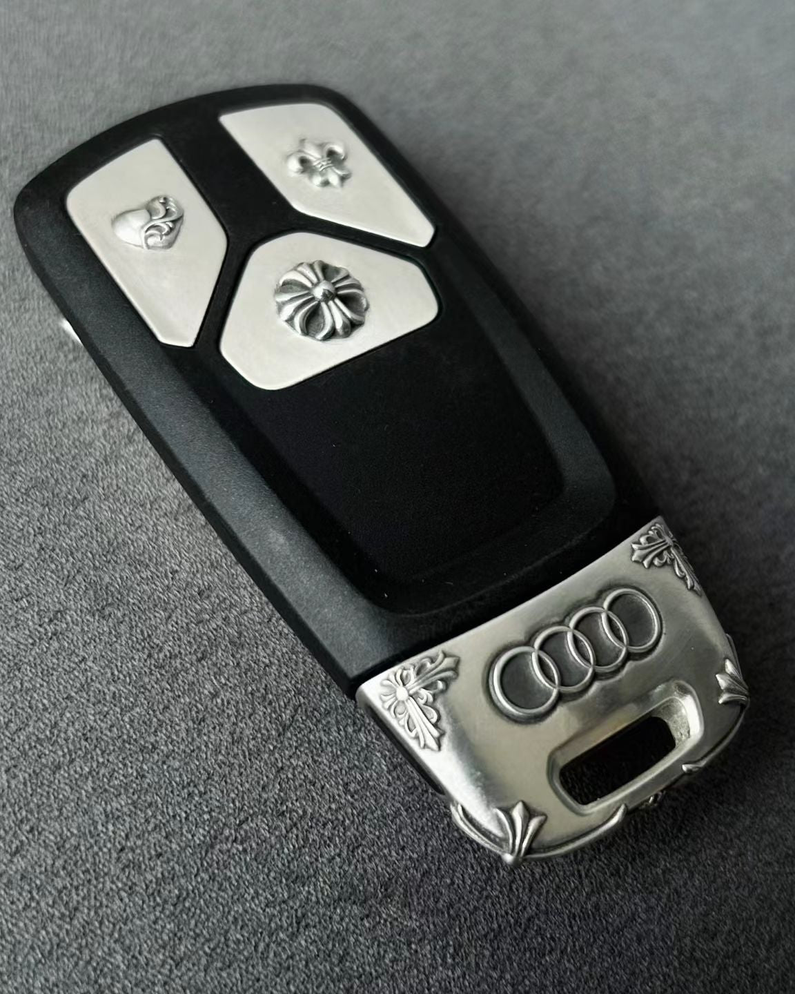 Original Audi tri-layout key before adding handcrafted silver case protection showing factory plastic housing