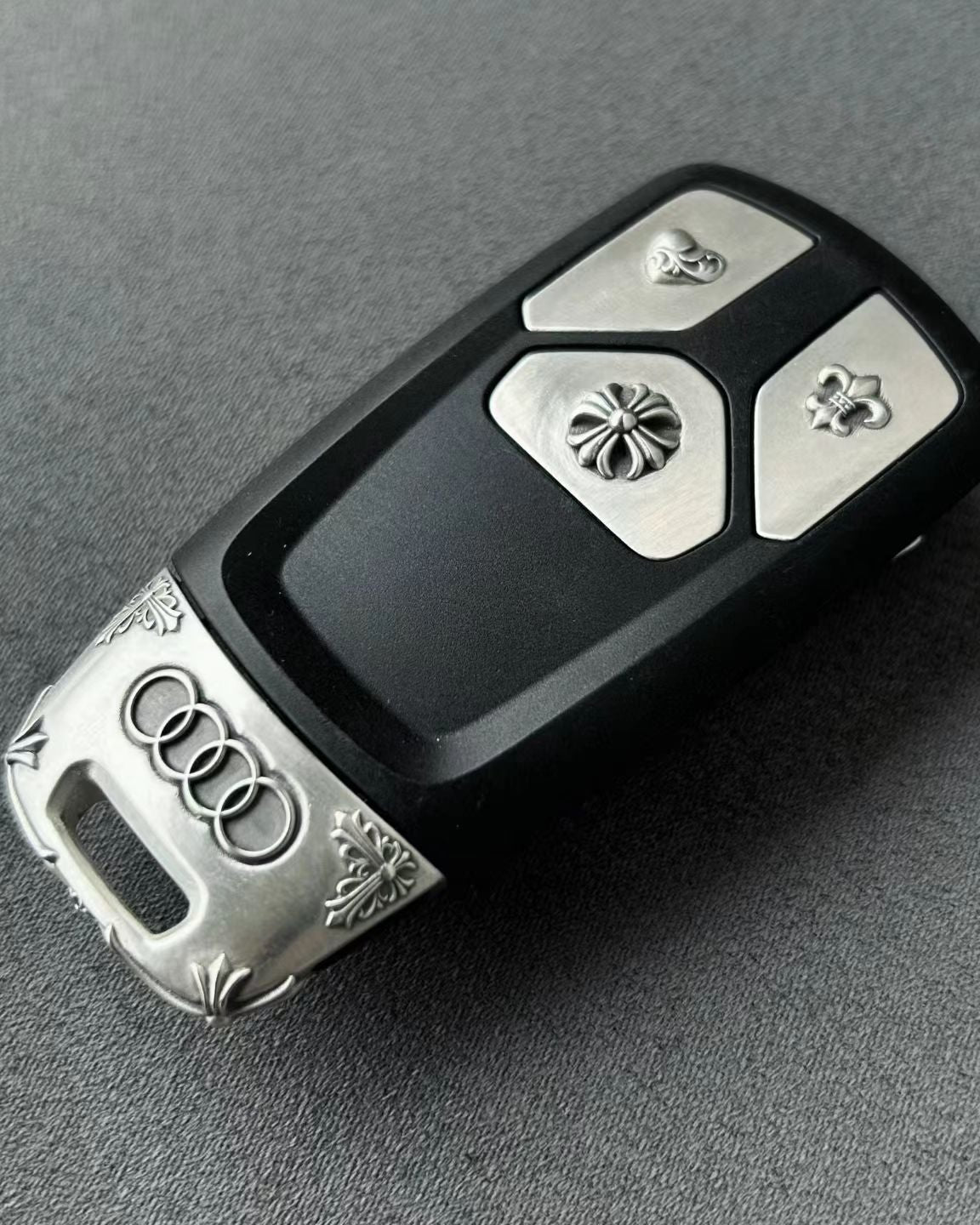 Substantial silver key case for Audi owner daily carry diagonal perspective showing refined weight