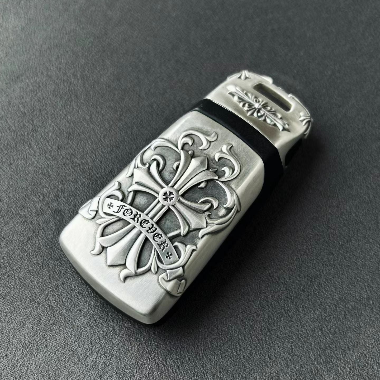 Understated luxury Audi key case flat lay presentation showcasing intentional weight and density