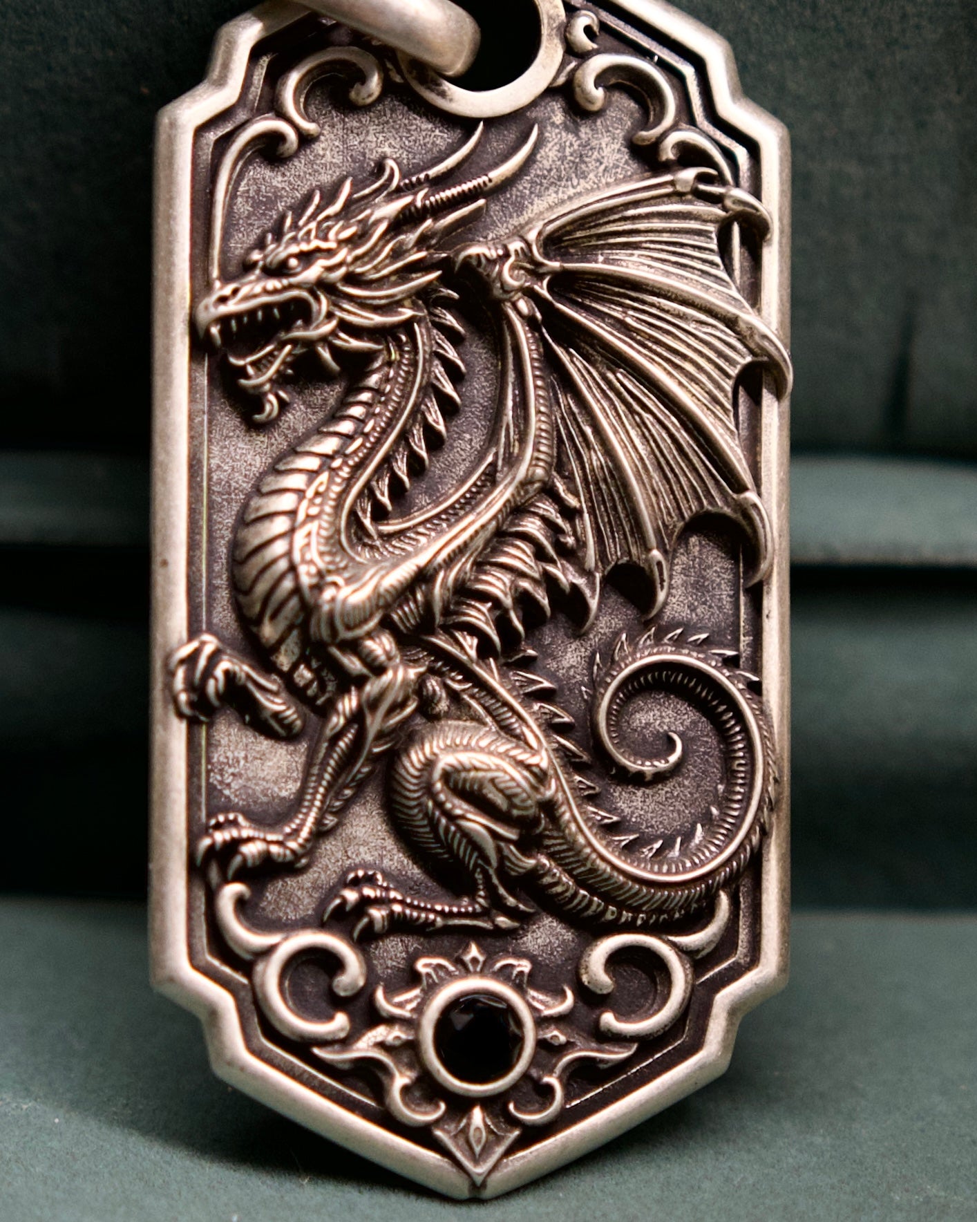 Bespoke dragon-motif key tag, dragon engraving close-up