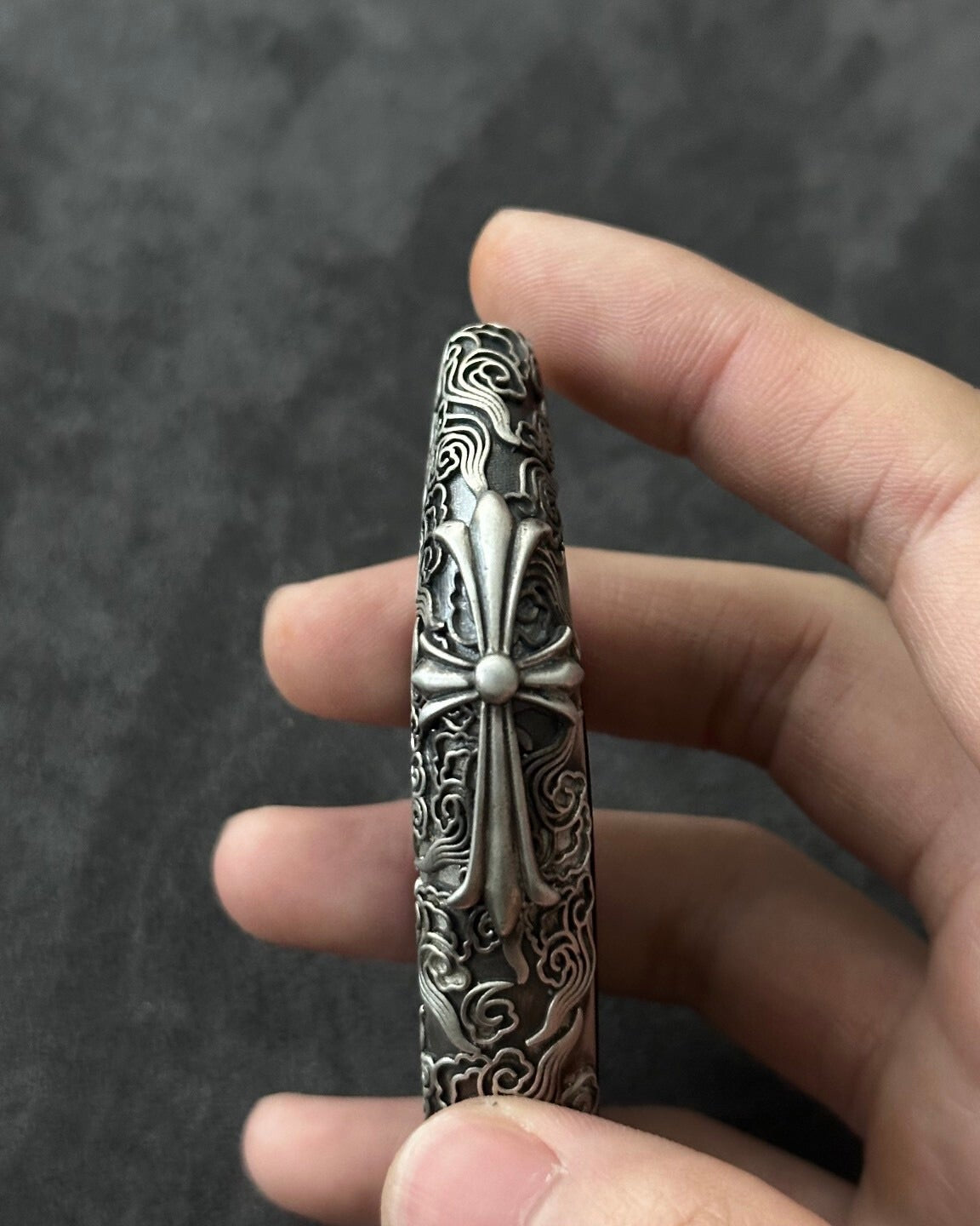 Male hand holding the BMW cloud style sterling silver key case, demonstrating substantial weight and comfortable grip for E60/E70 owners
