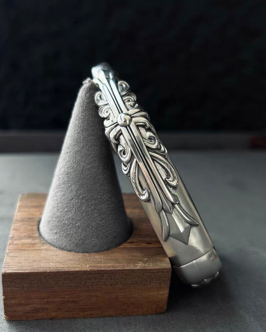 BMW slim edge key case standing presentation on wooden stand with gray display holder showcasing substantial build and side engraving