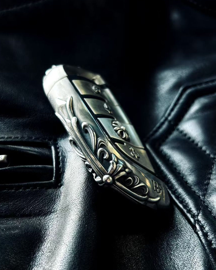 BMW slim edge key case paired with metal sunglasses on black leather background suggesting automotive interior and premium accessories coordination