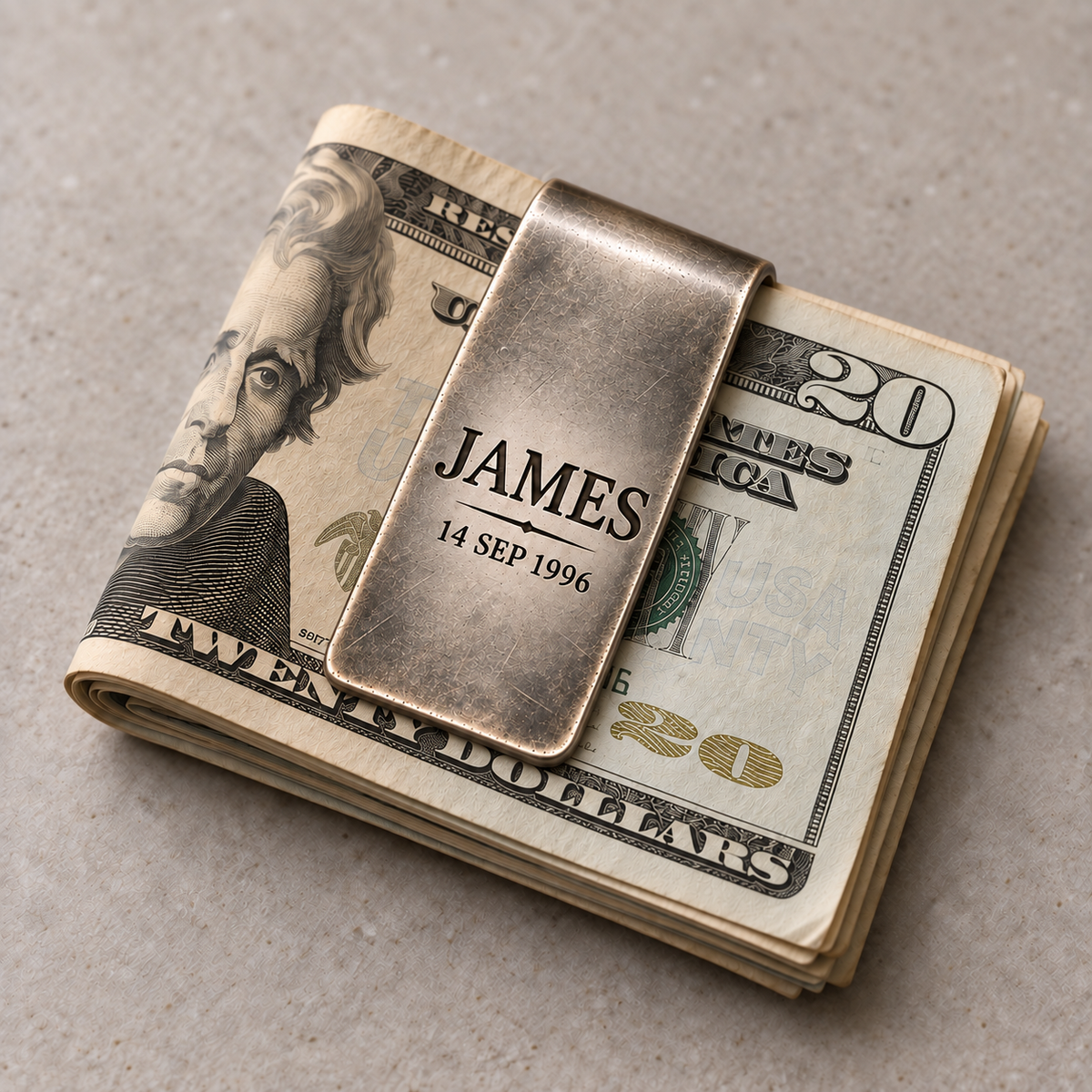 Folded US bills held securely by a personalized engraved money clip