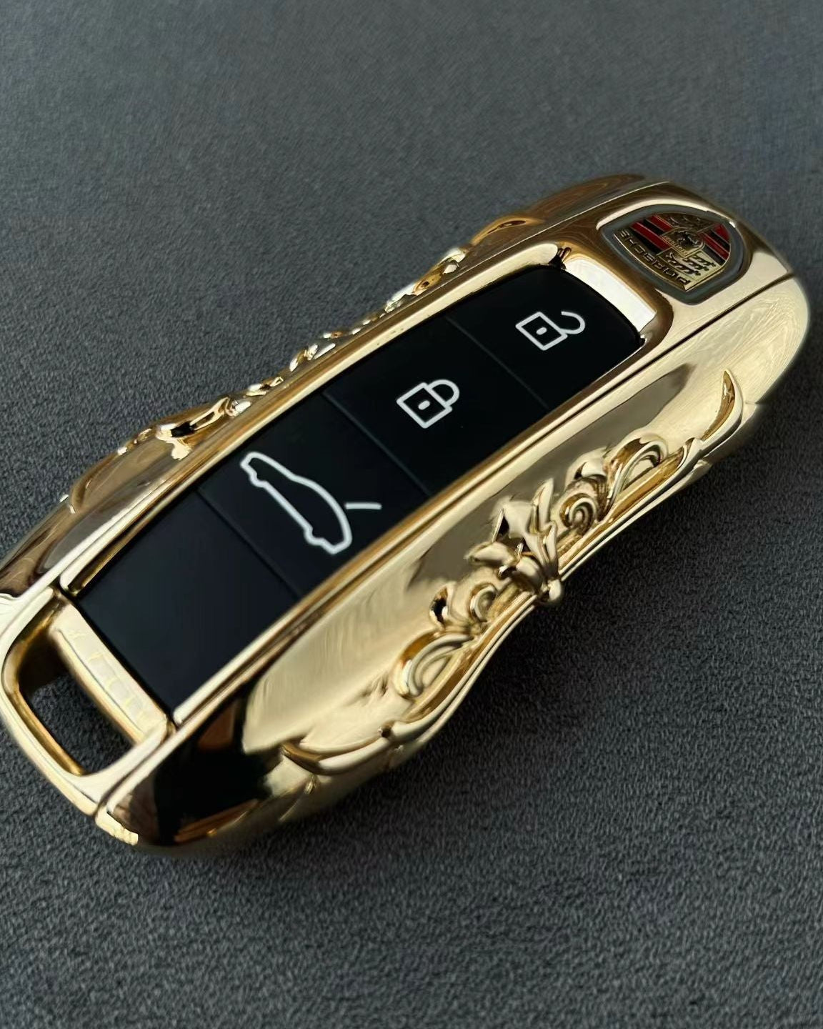 Custom IGNIS ARGENTUM 18K Gold key case with hand-engraved ornate scrollwork, showcasing exceptional refinement and substantial presence, precision-machined to factory remote