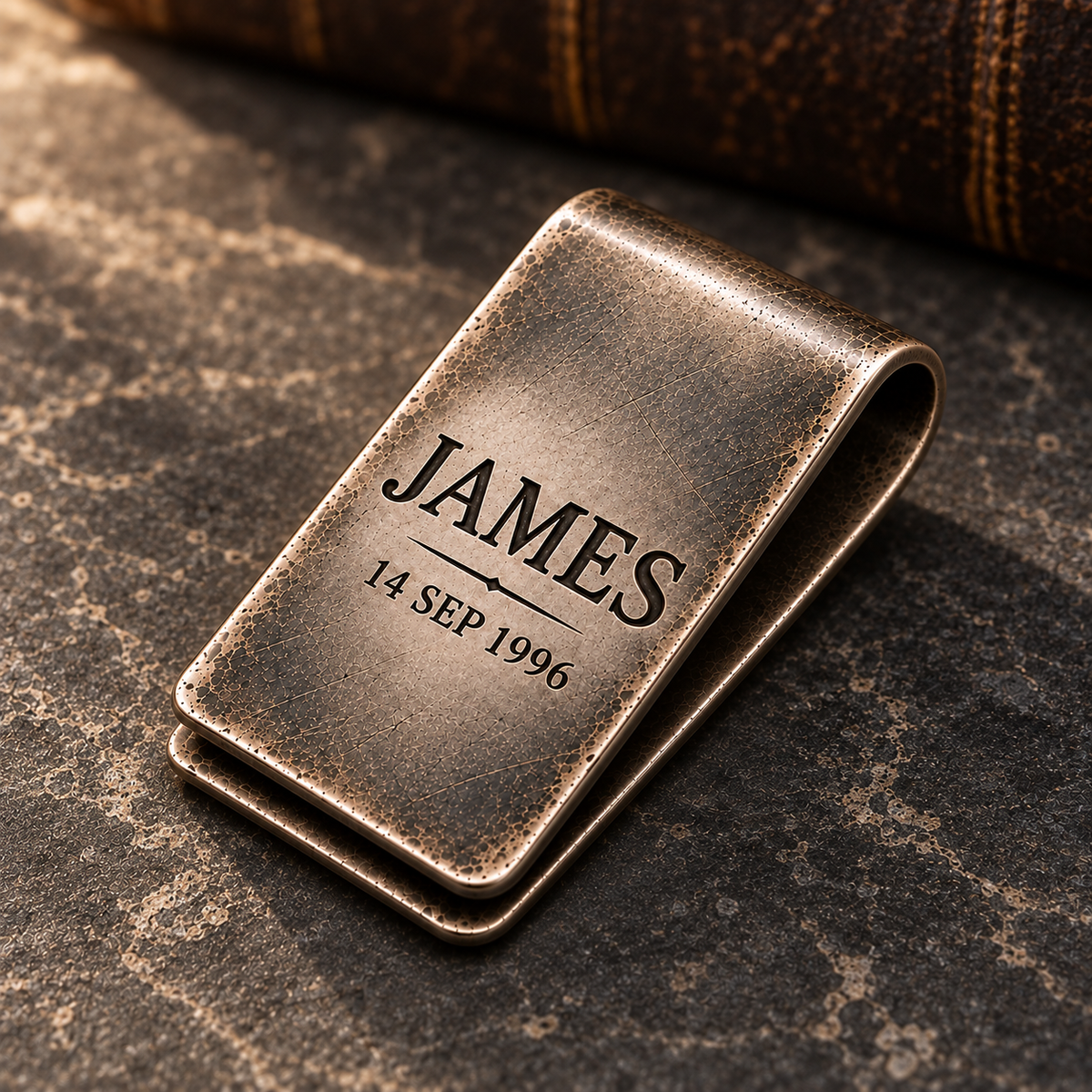 Antique silver engraved money clip shown at a realistic 45 degree angle