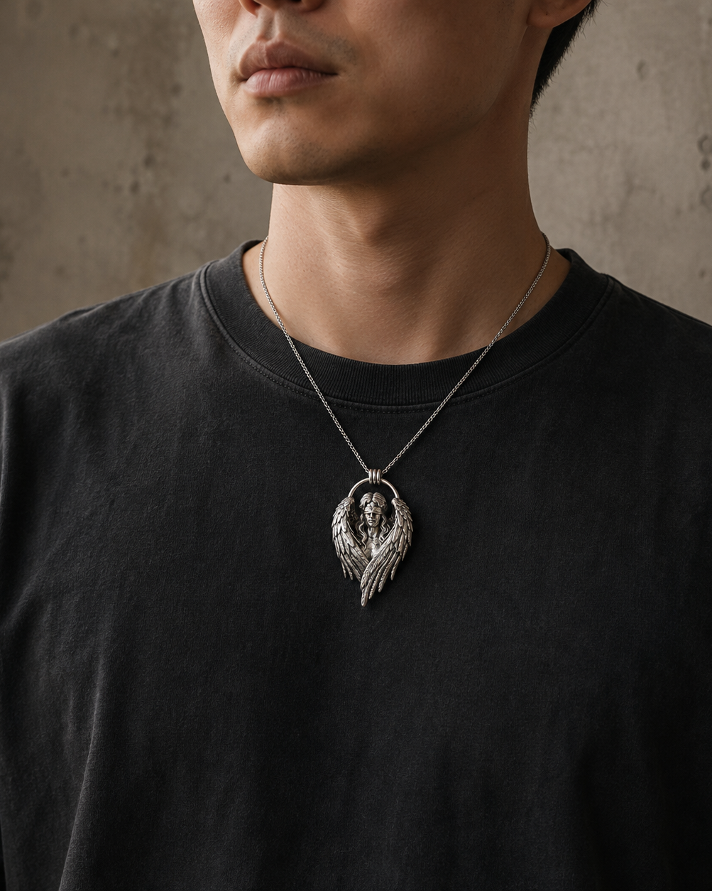 Fallen Angel Blindfolded Pendant, worn on a chain