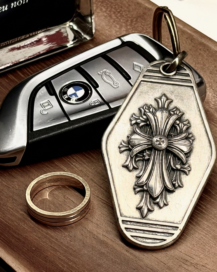 Gothic Fleur Cross Silver Keychain, front view beside a car key