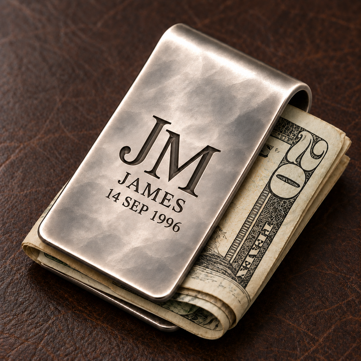 Personalized hand-planished money clip securely holding folded cash