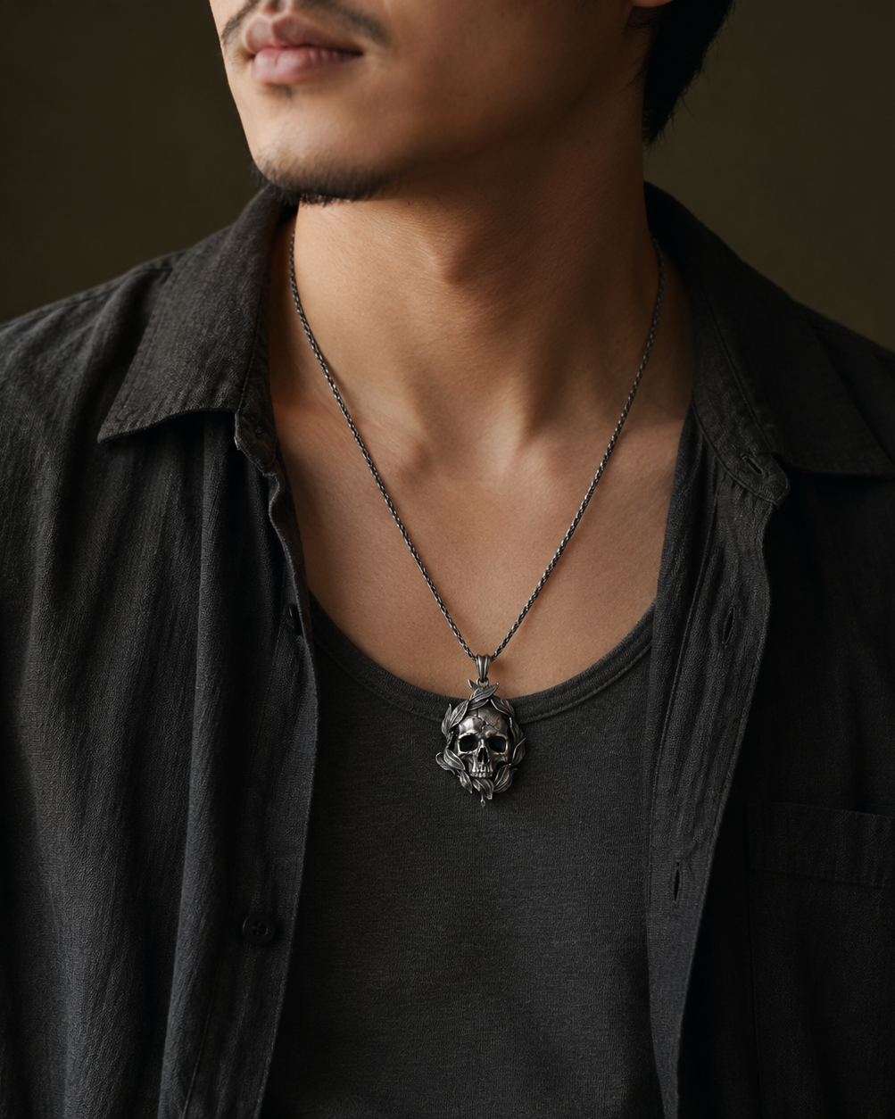 Memento Mori Skull & Feather Pendant, displayed on a dark surface