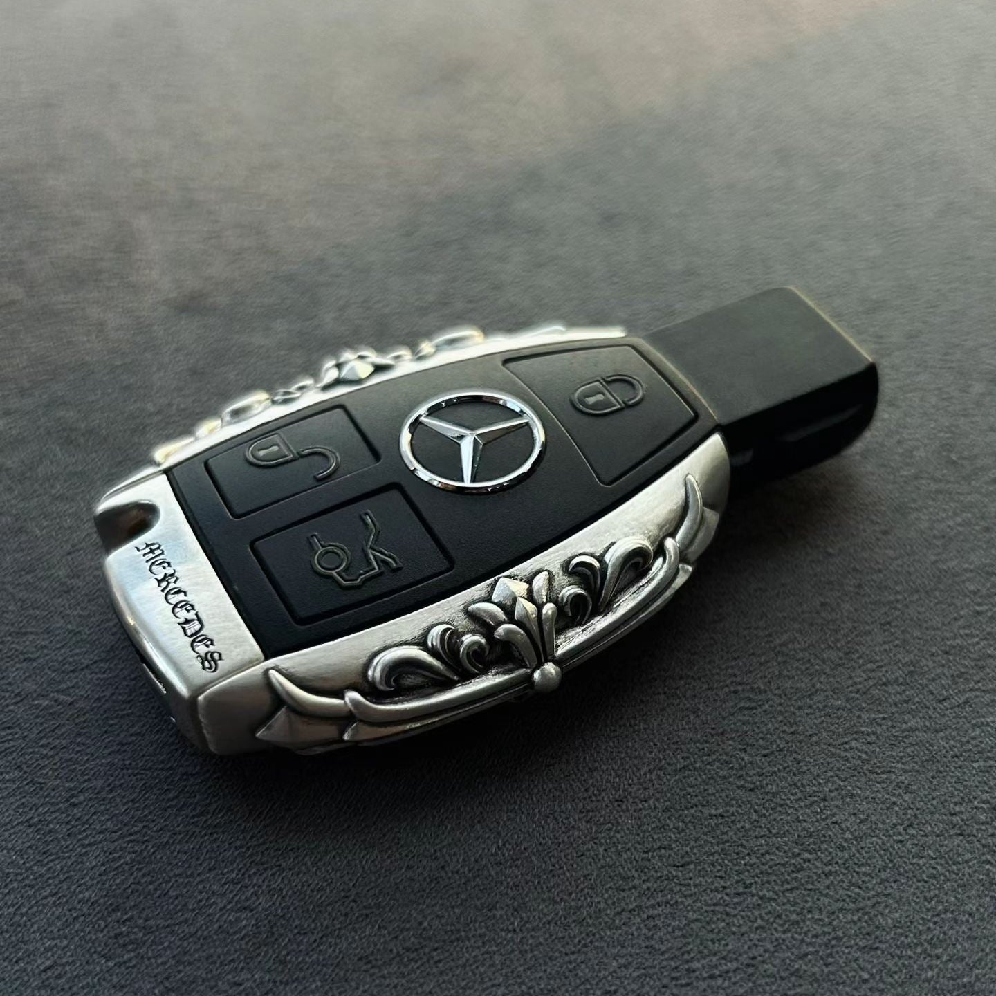 Mercedes classic oval key case front view showing precision button cutouts and engraved top surface without interfering original lock unlock trunk functions