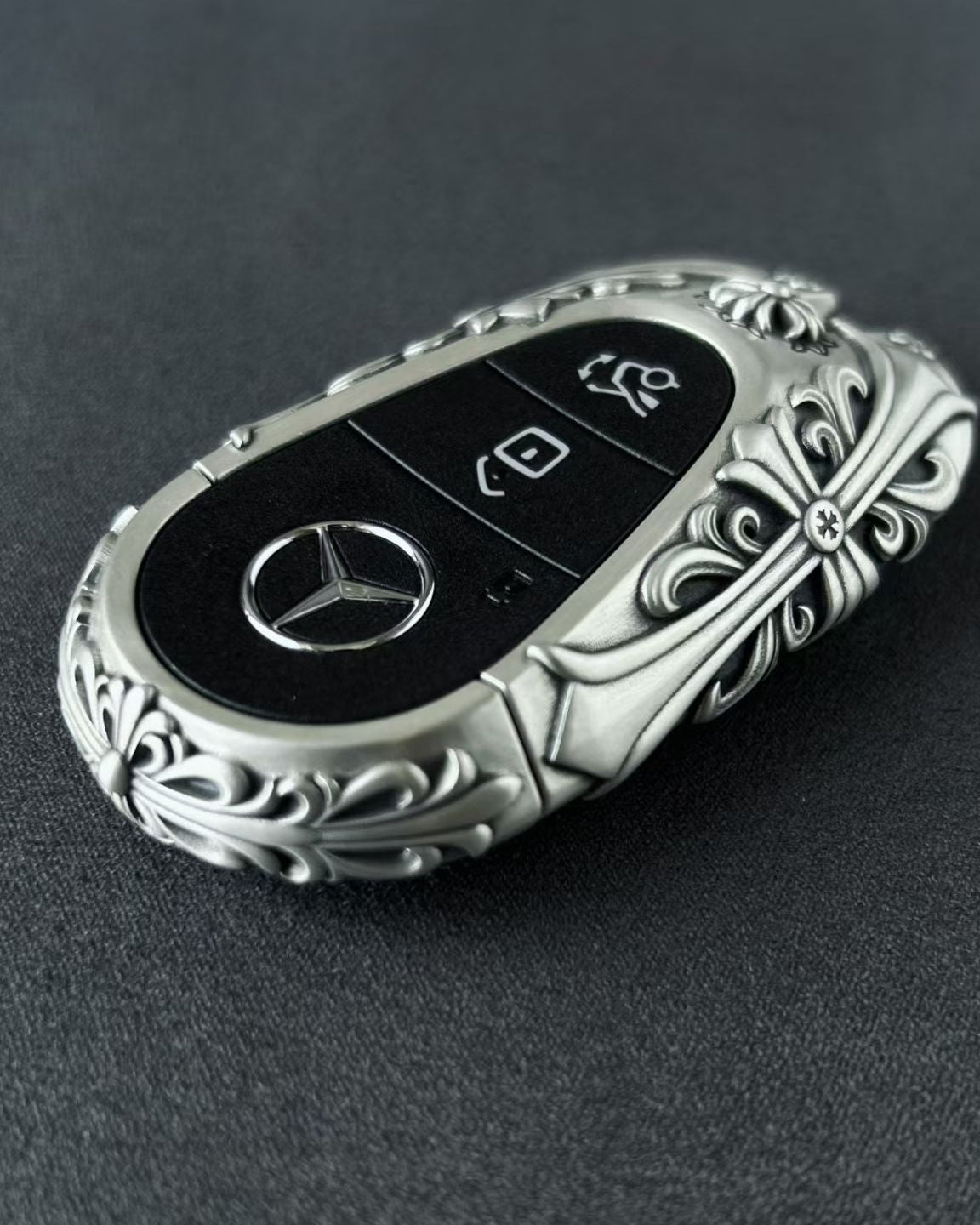 Handmade silver key case for Mercedes back view showing brand engraving and metal texture with intentional weight and density
