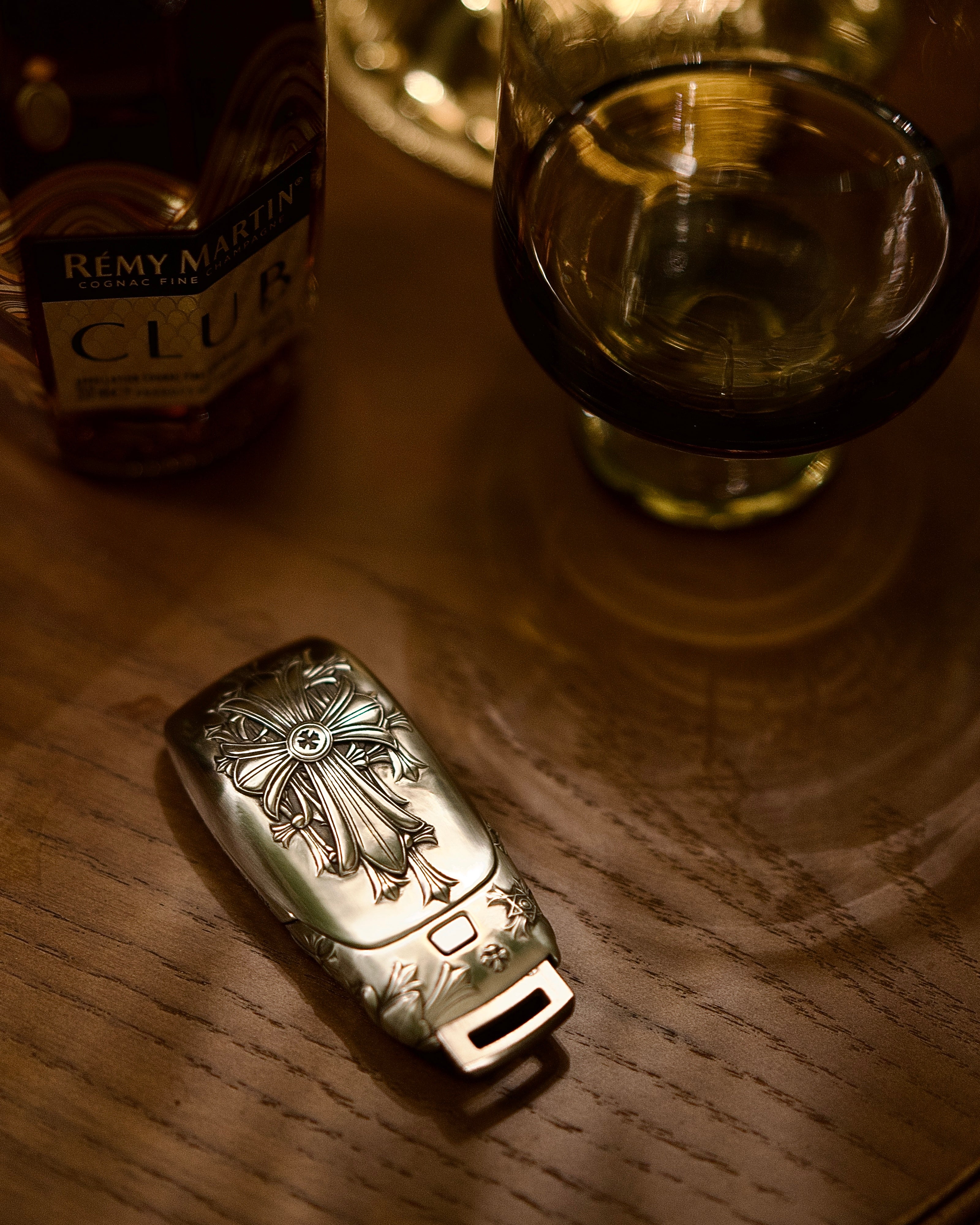 Mercedes slim rectangle key case diagonal side profile leaning on wooden block showing weighty precision and continuous engraving pattern