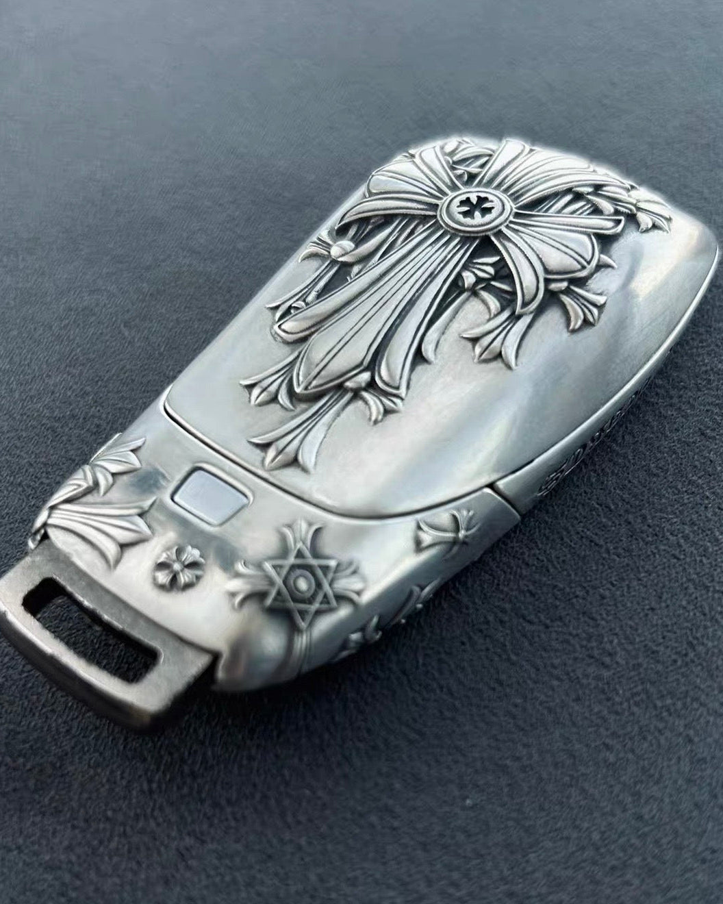 Mercedes slim rectangle key case standing presentation on wooden block solid blue background highlighting substantial build and refined patina