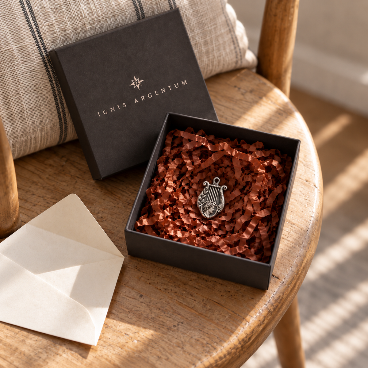 Apollo MYTHOS charm — IGNIS ARGENTUM gift box styling; design visualization