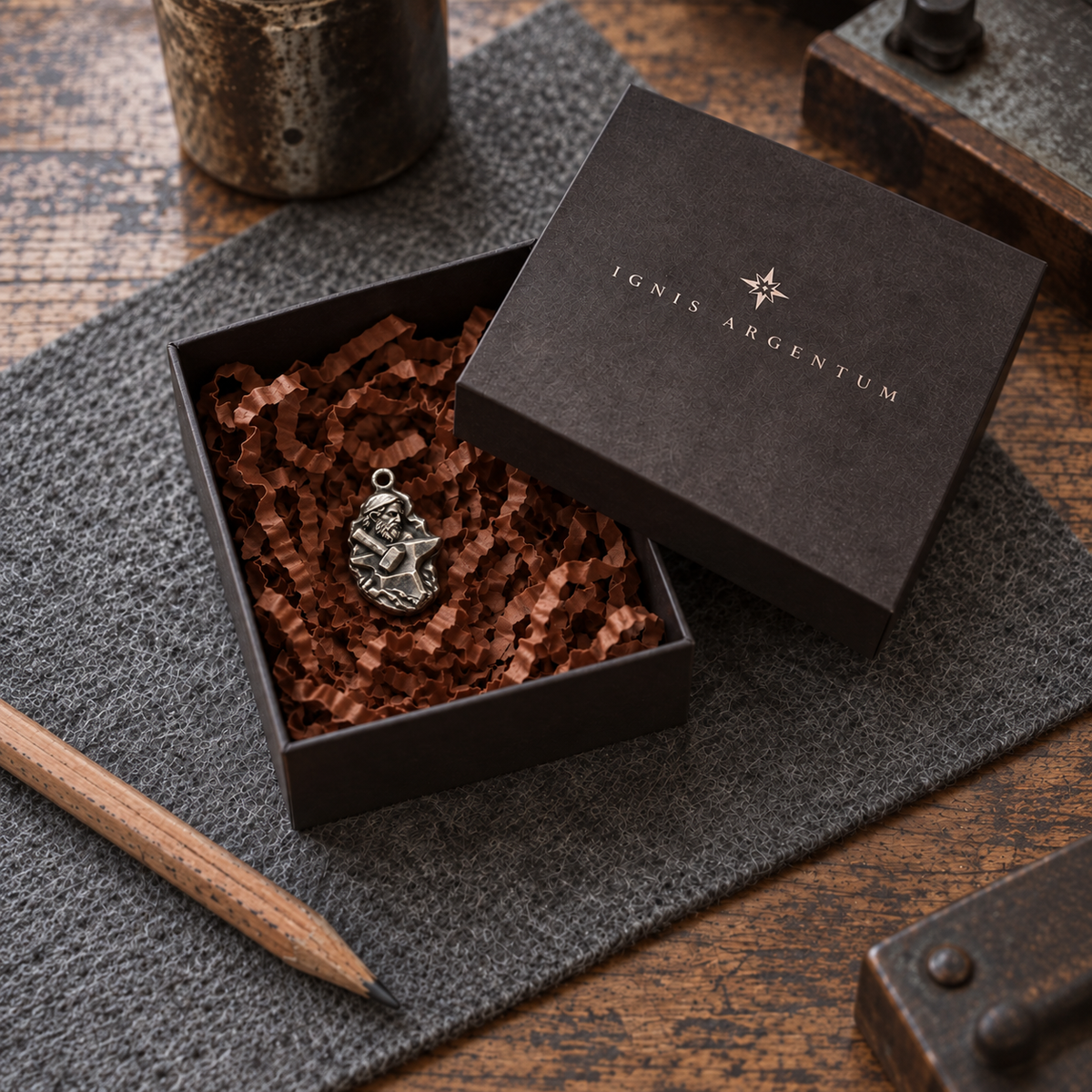 Hephaestus MYTHOS charm — IGNIS ARGENTUM gift box styling; design visualization