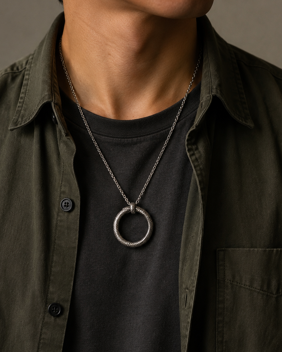 Ouroboros Serpent Circle Pendant, held for scale