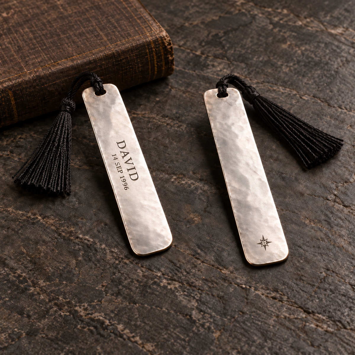 Front and back views of one bookmark; customer name and date on front, small brand logo on back