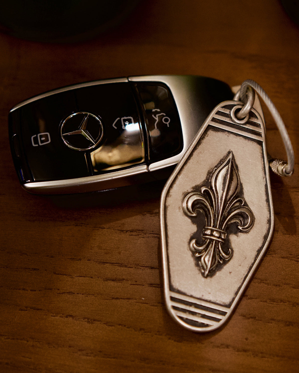 Royal Fleur Personalized Silver Keychain, front view beside a car key
