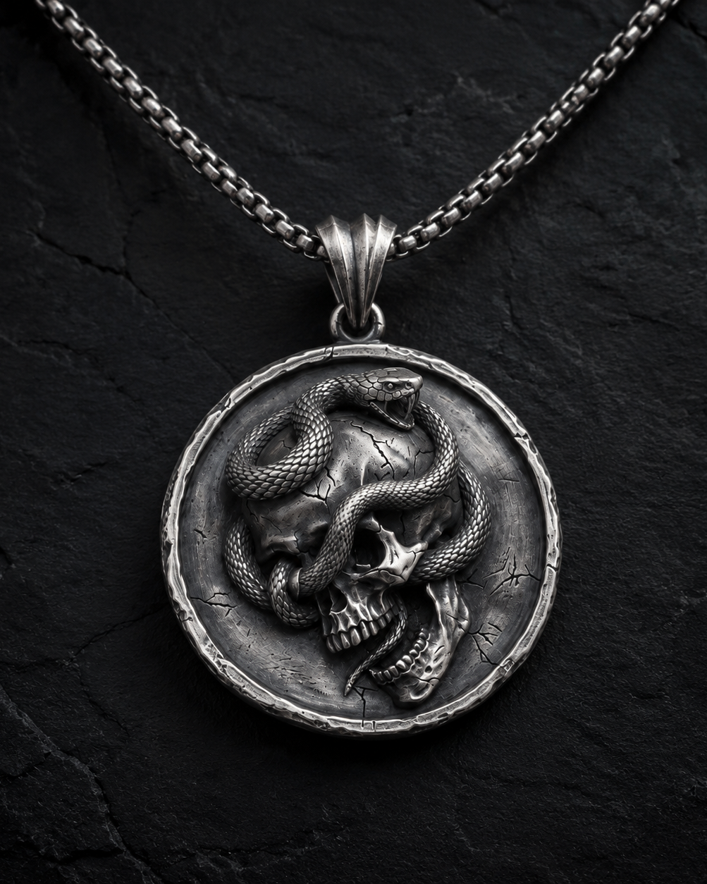 Serpent Skull Medallion Pendant, displayed on a dark surface
