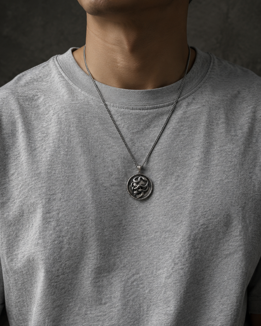 Serpent Skull Medallion Pendant, held for scale