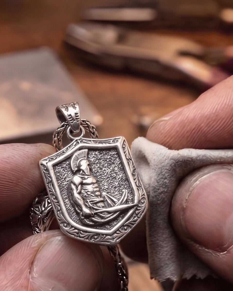 Spartan Shield & Sword Pendant, held for scale