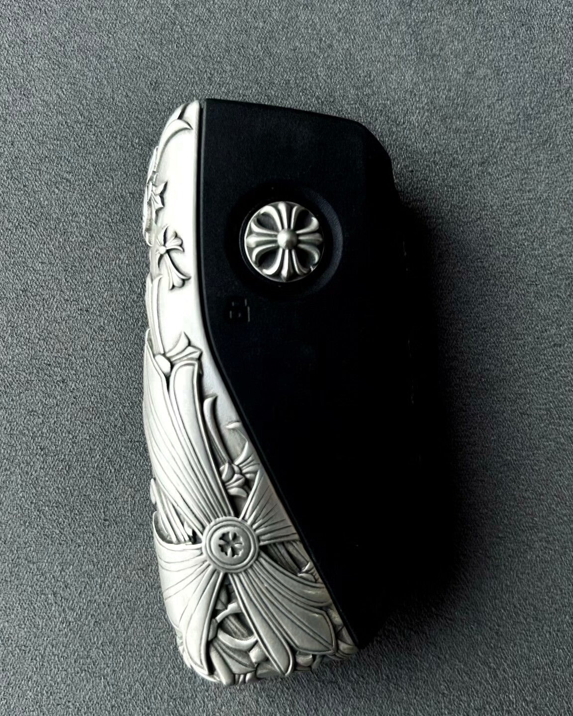 Hand holding precision-crafted BMW key case, demonstrating substantial weight