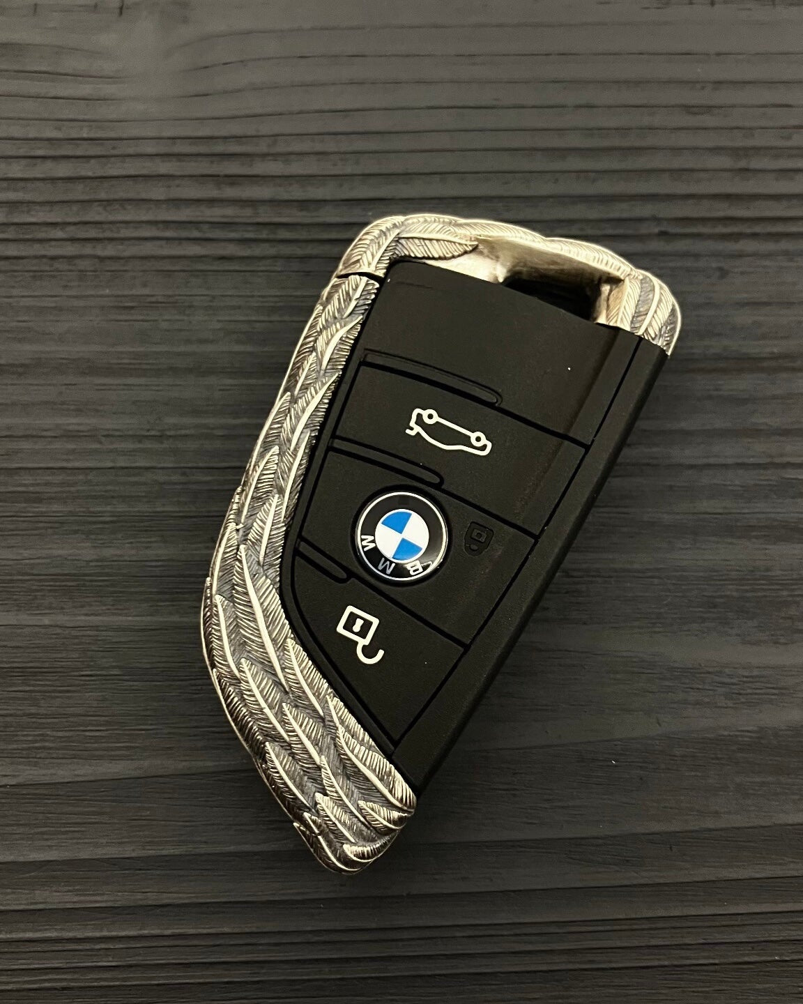 Back view showing continuous feather texture pattern on 925 Sterling Silver BMW key case