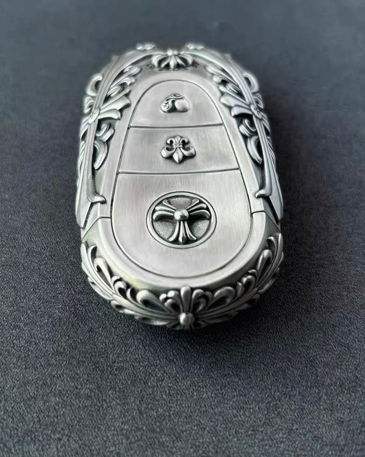 Hand holding precision-crafted Mercedes key case, demonstrating substantial weight