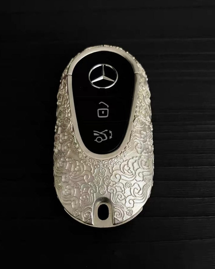 Top angle view of hand-finished Mercedes key case with matte cloud texture details
