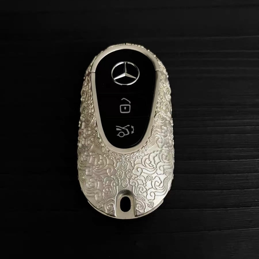 Top angle view of hand-finished Mercedes key case with matte cloud texture details