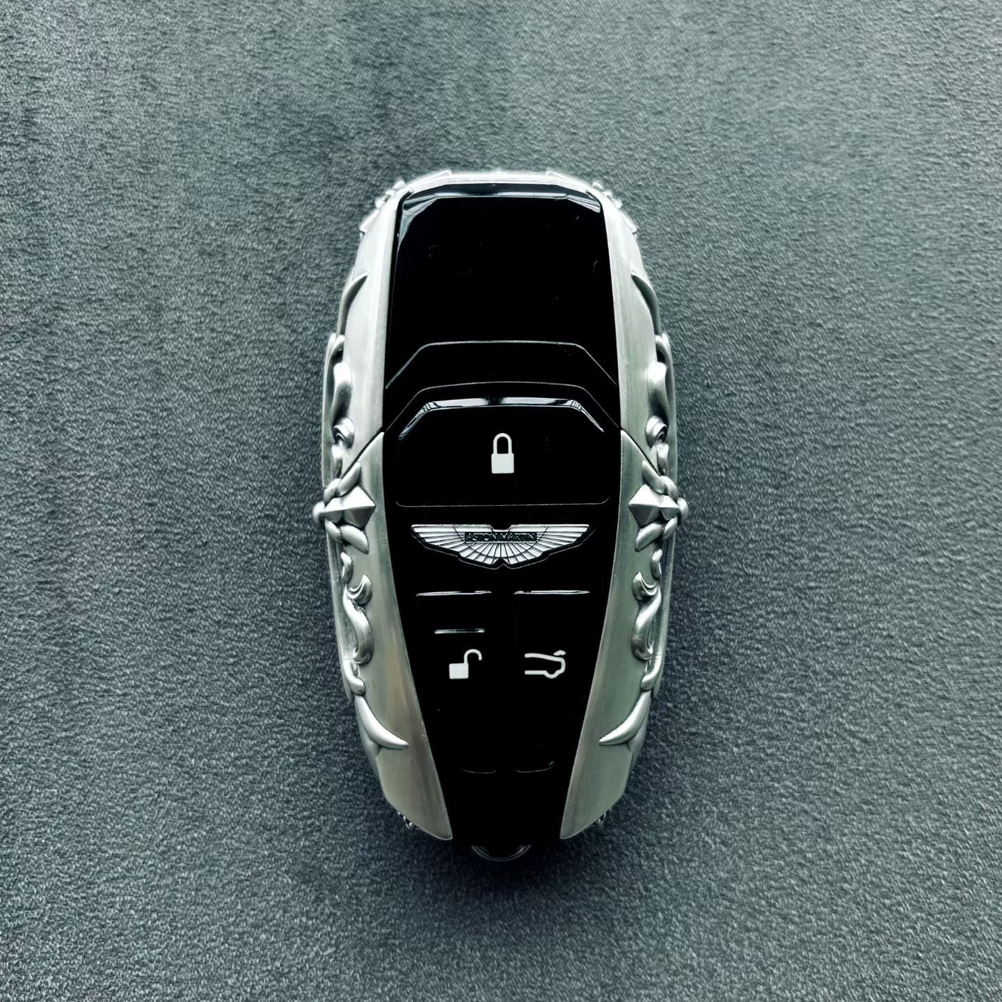 Back view of handcrafted sterling silver key case showing scrollwork and material depth