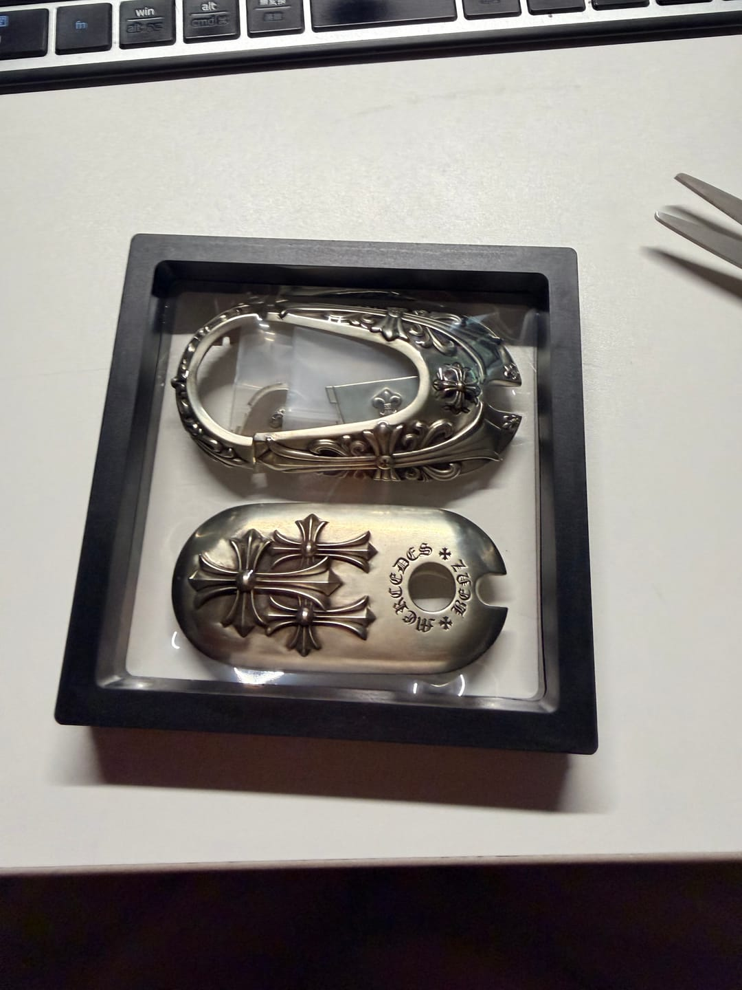 Customer unboxing photo showing an IGNIS ARGENTUM key case with precise fit and premium presentation