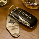 Custom name and date engraving example on a metal key tag