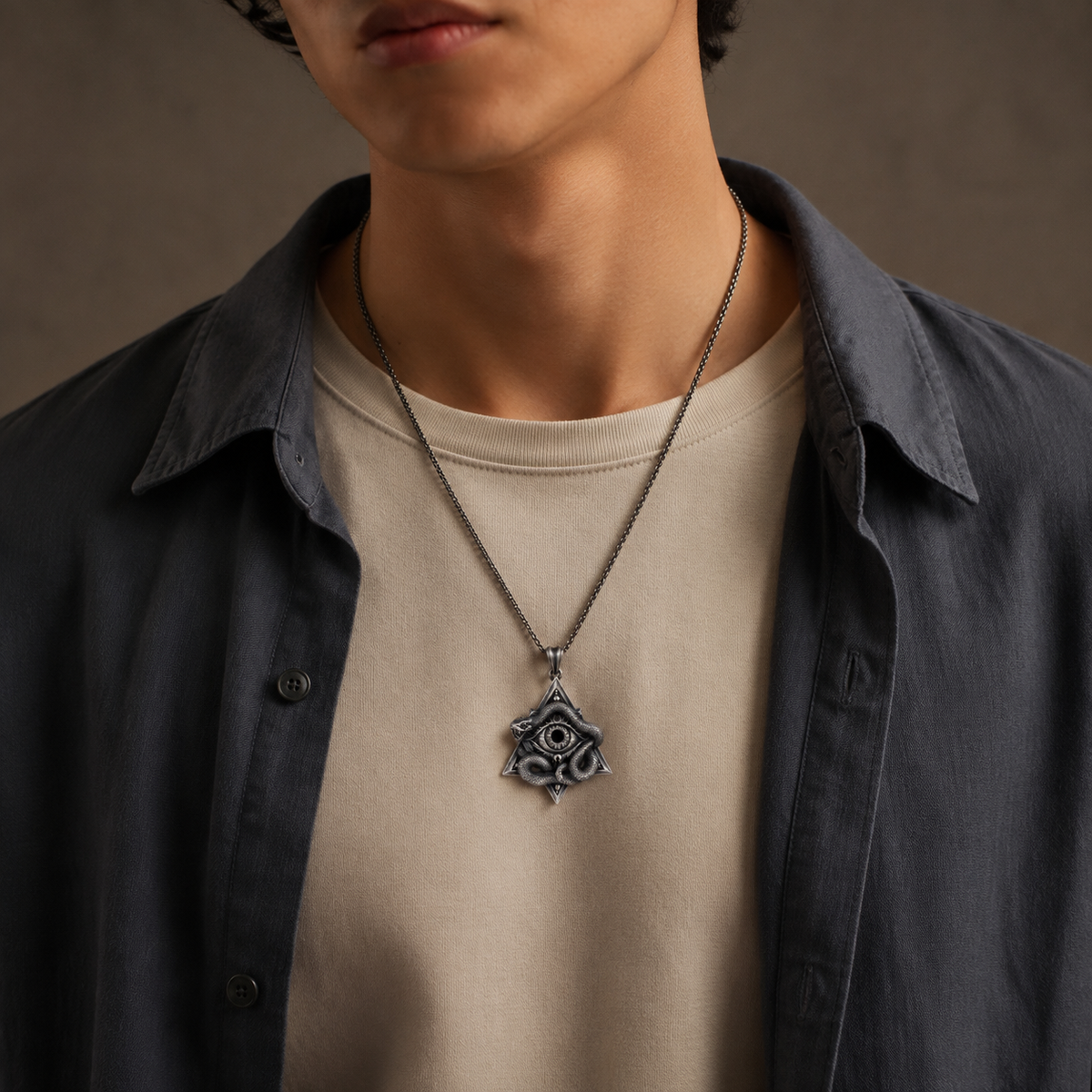 All-Seeing Eye Serpent Pendant, displayed on a dark surface
