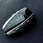 Aston Martin handcrafted sterling silver key case side 45-degree angle highlighting substantial thickness, sculpted silver edges and intentional weight (90g) with refined patina