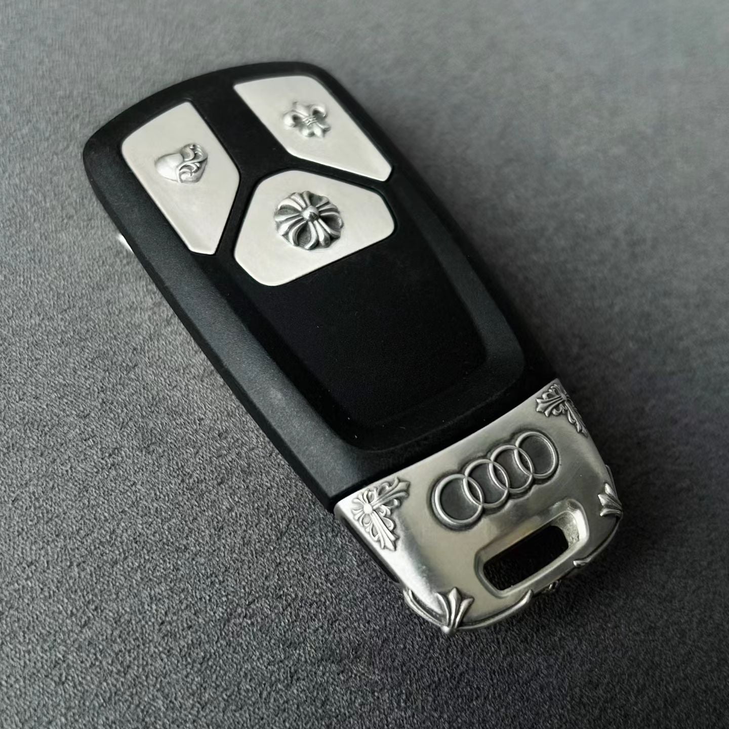 Original Audi tri-layout key before adding handcrafted silver case protection showing factory plastic housing