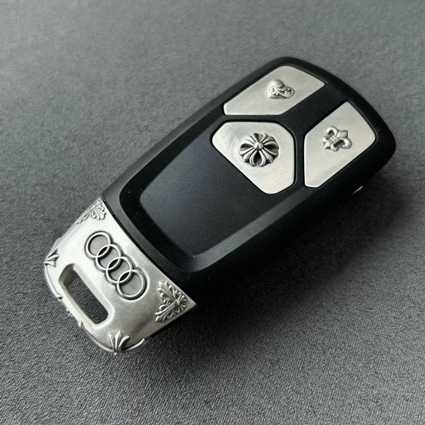 Substantial silver key case for Audi owner daily carry diagonal perspective showing refined weight