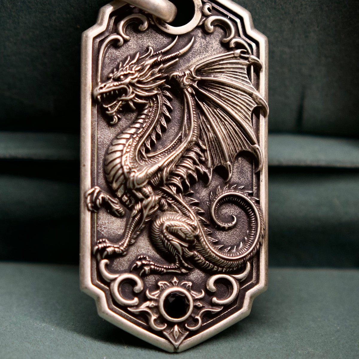 Bespoke dragon-motif key tag, dragon engraving close-up
