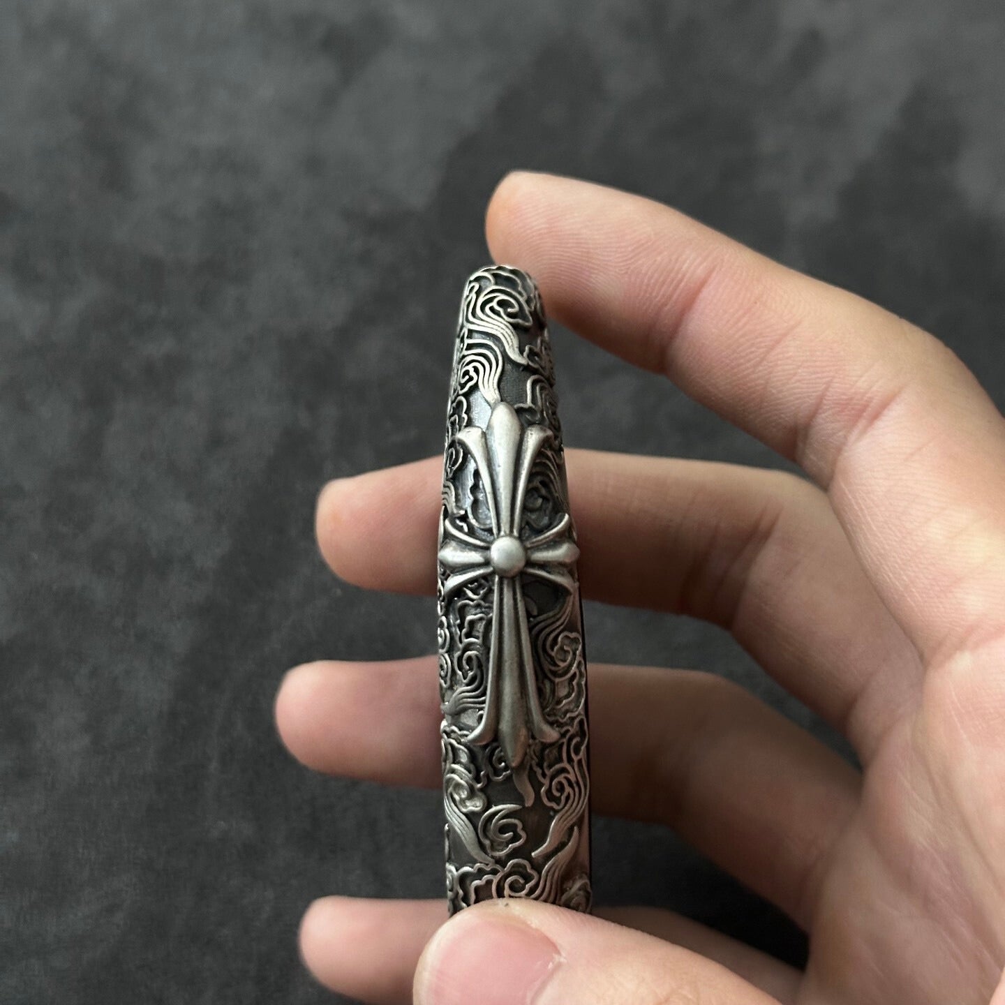 Male hand holding the BMW cloud style sterling silver key case, demonstrating substantial weight and comfortable grip for E60/E70 owners