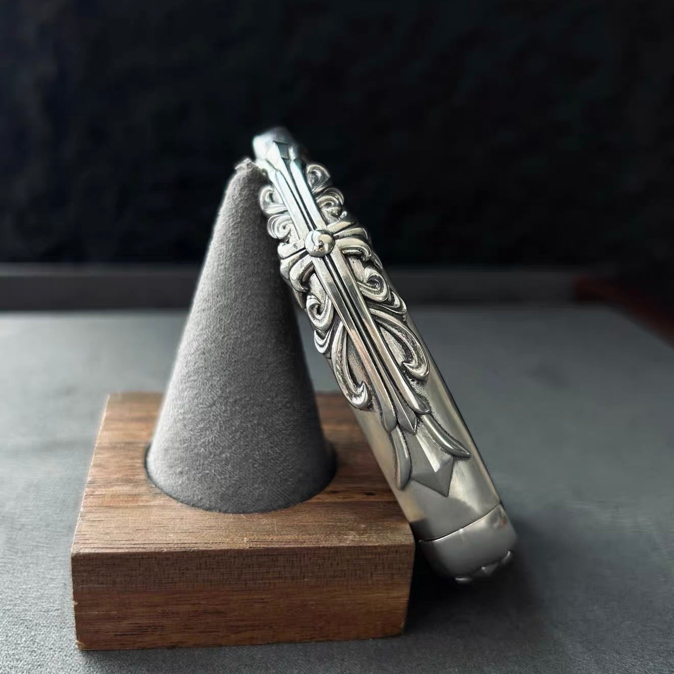 BMW slim edge key case standing presentation on wooden stand with gray display holder showcasing substantial build and side engraving