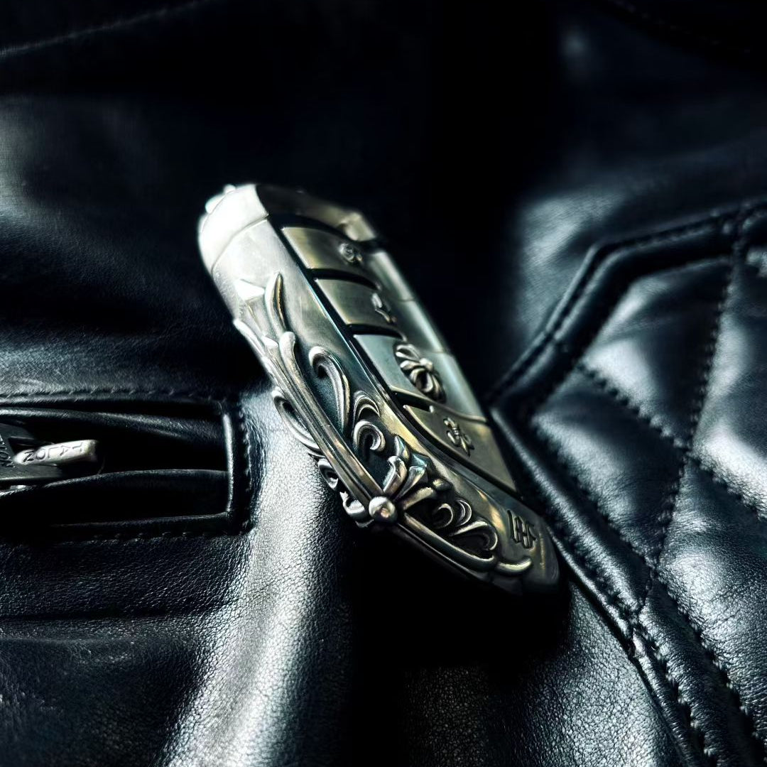 BMW slim edge key case paired with metal sunglasses on black leather background suggesting automotive interior and premium accessories coordination