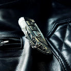 BMW slim edge key case paired with metal sunglasses on black leather background suggesting automotive interior and premium accessories coordination