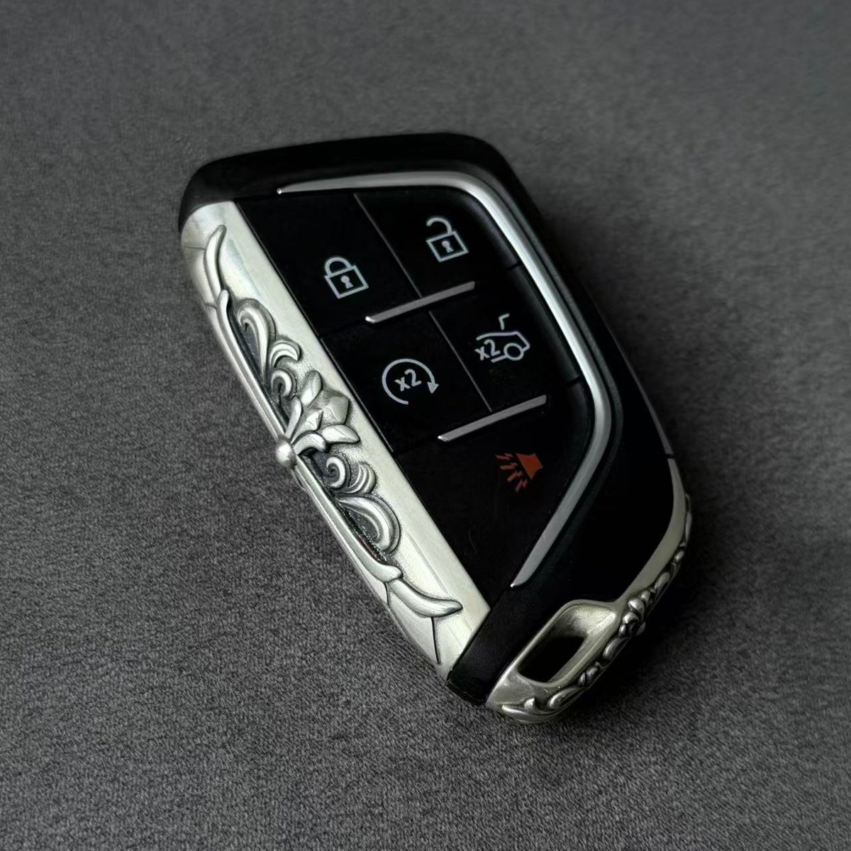 Cadillac Silver Key Case for 4/5/6-Button Keys, held for scale